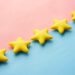 five yellow stars on blue and pink background